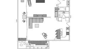 Un plan d’étage d’une chambre d’hôtel comprenant un lit, un coin salon, une kitchenette, une salle de bain et un petit balcon.