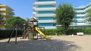 Apartment, 1 Bedroom, Balcony | Children’s area - Enjoy a Comfy Flat With Shared Pool - Beahost (San Michele al Tagliamento)