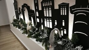 A decorative wall with cut-out silhouettes of buildings and a gnome figure. - New Studio 3 Downtown Thessaloniki-fully Equipped (Thessaloniki)