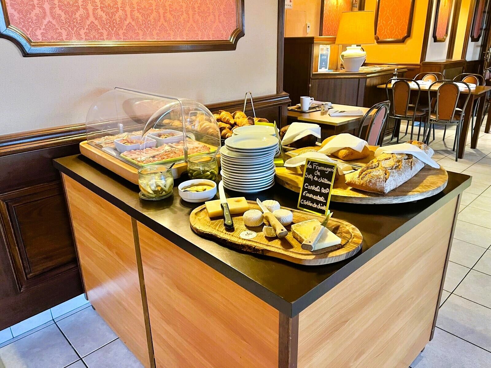 Een ontbijtbuffet met diverse soorten eten en een bord waarop de menukaart staat.