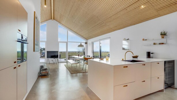 A modern kitchen with large windows, a wooden ceiling, and a view of the countryside. - 4 bedroom cozy home in Haderslev (Haderslev)