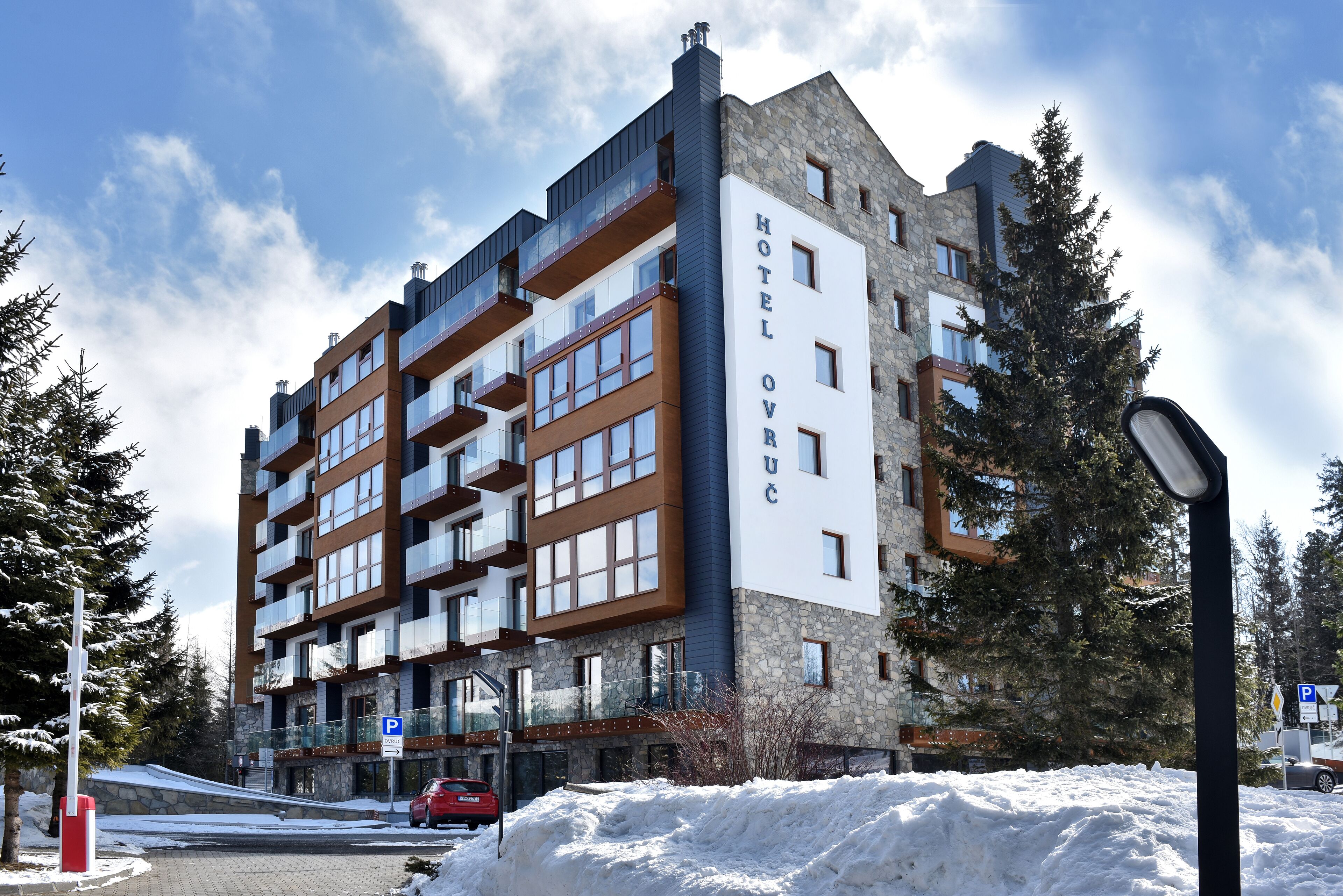 A multi-story hotel with a stone facade and balconies.