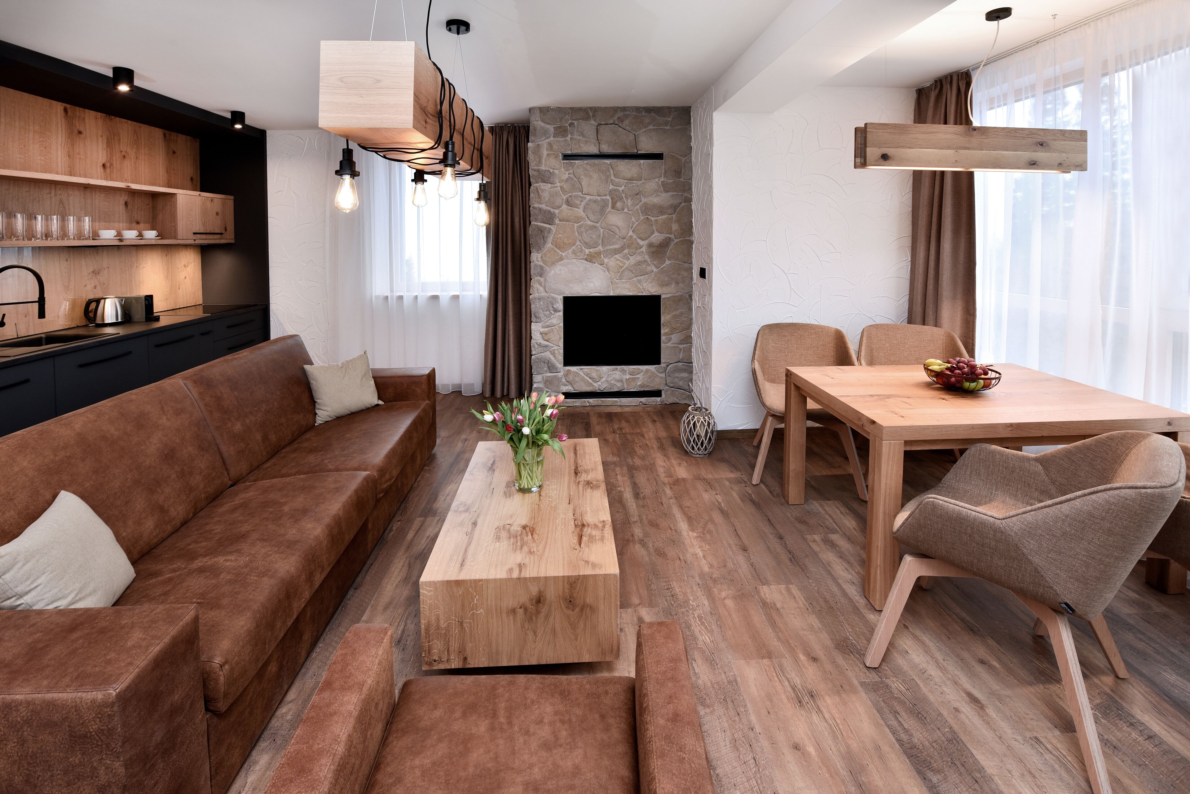 A modern living room with a sofa, coffee table, and dining area.