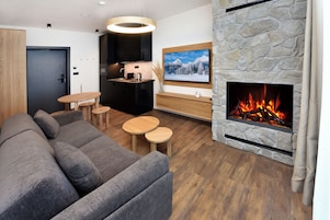 Standard Studio Suite | Living area | 40-inch flat-screen TV with satellite channels, TV, heated floors