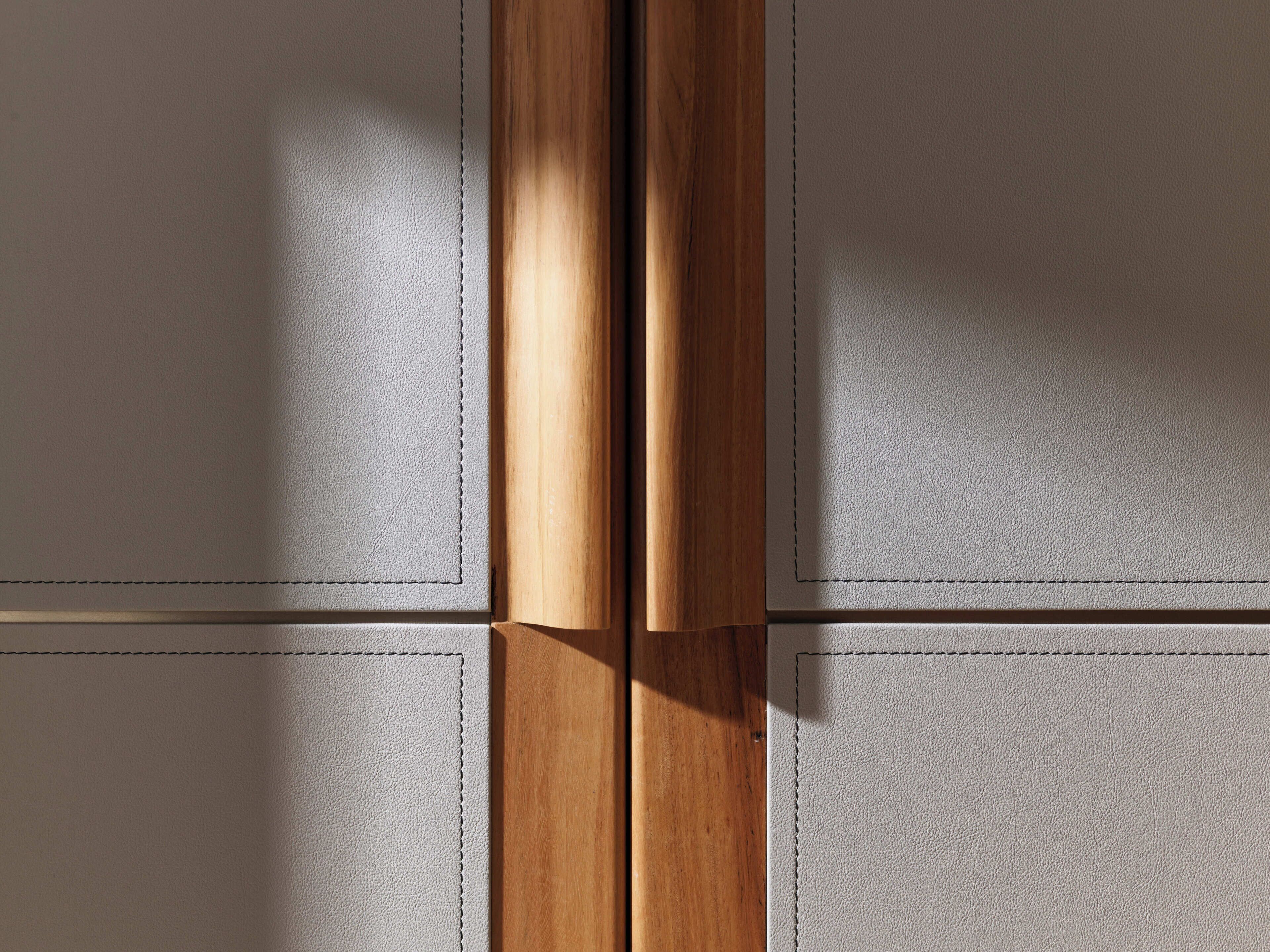 A close-up of a wooden door with a textured surface, likely made of leather or a similar material.