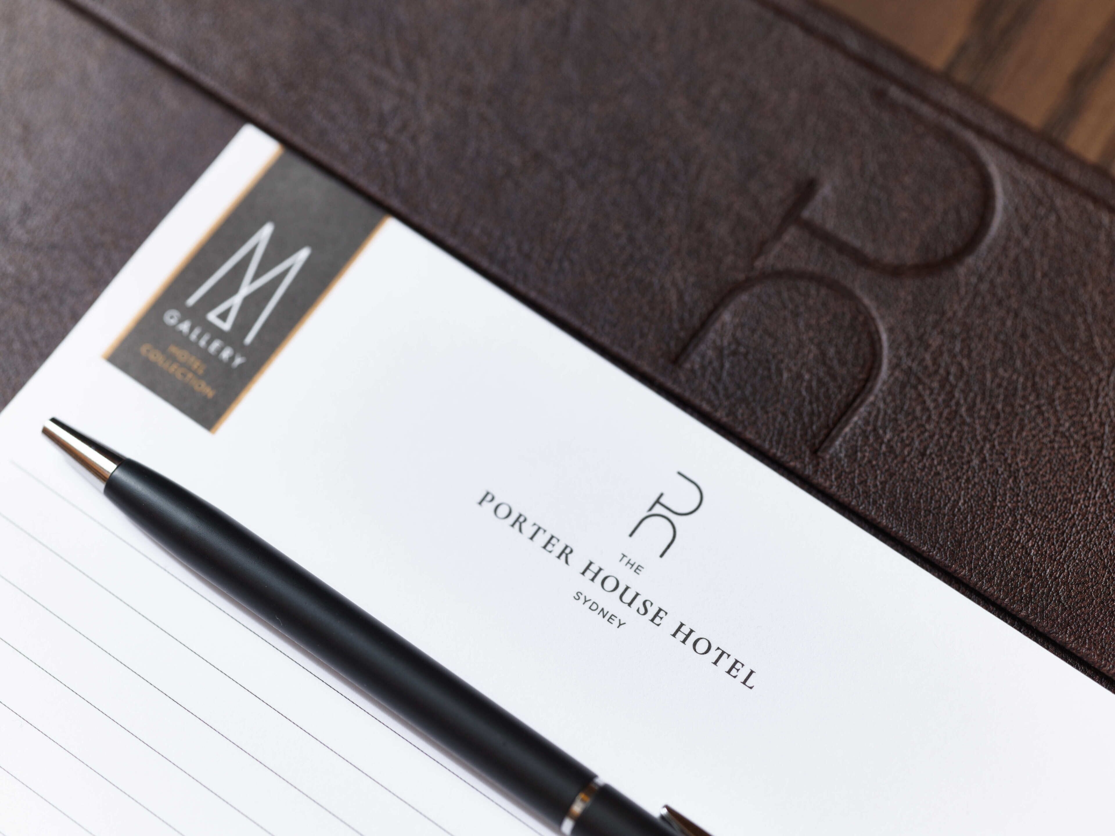 A hotel brochure titled "Porter House Hotel" with a pen on top.