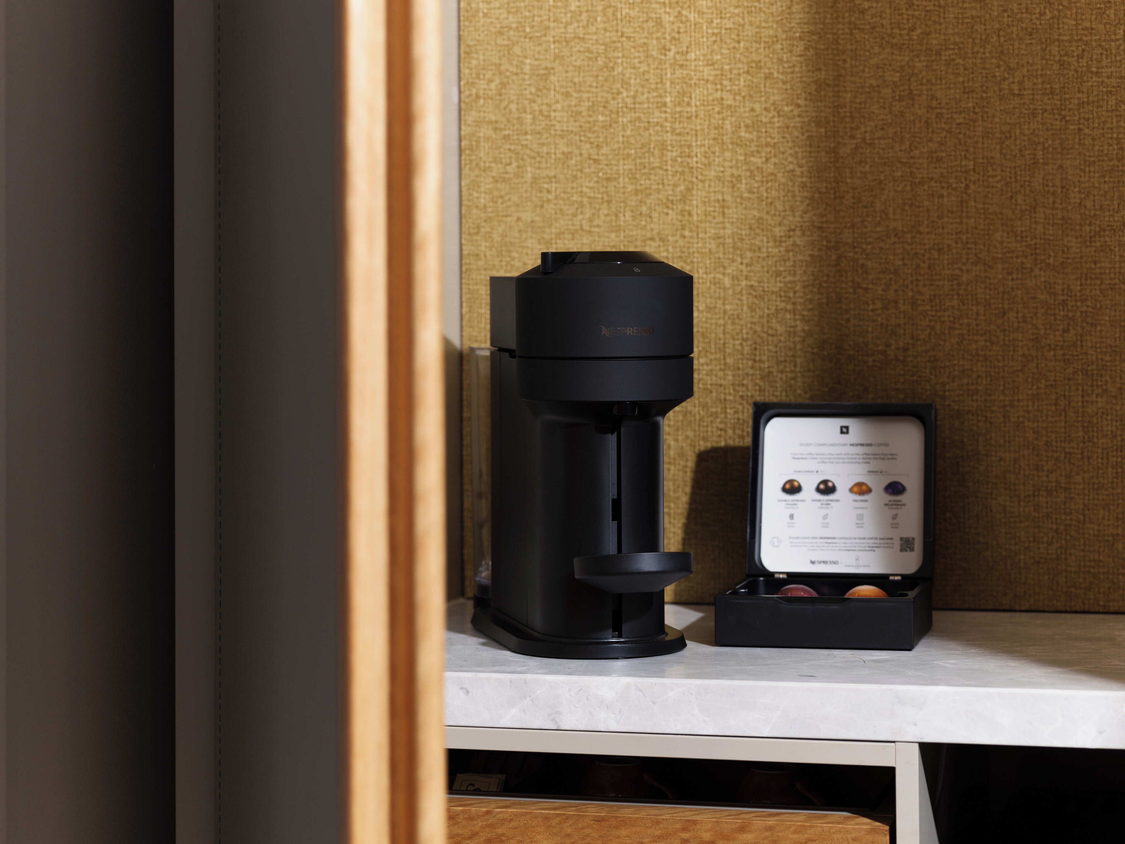 A coffee machine with a manual on the counter.