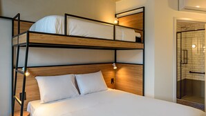 A bunk bed with two levels, a wooden headboard, and bedside lamps.