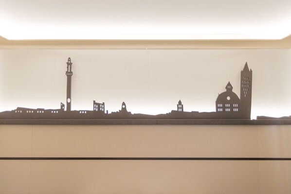 A silhouette of a city skyline with distinct buildings, including a clock tower and a dome structure. - Palace Hotel Due Ponti (Siena)