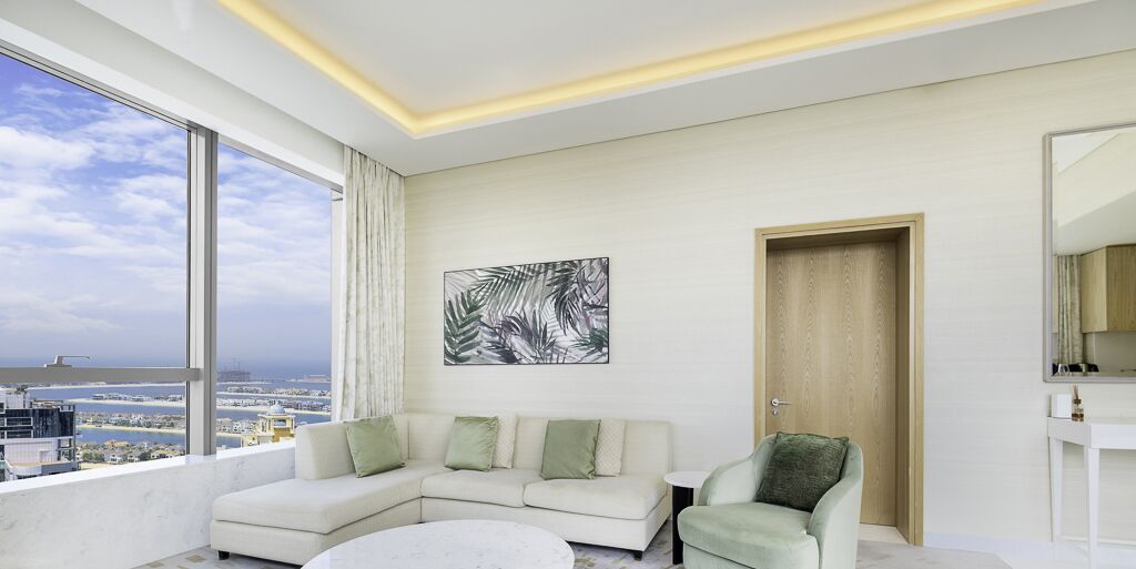 A modern living room with a large window, a sofa, a chair, and a painting on the wall.