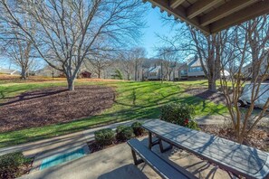 A residential area with a picnic table, a swimming pool, and houses in the background. - Fairway Villa 604 at Rumbling Bald (Lake Lure)