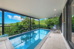 A private pool with a clear view of the surrounding greenery and hills.