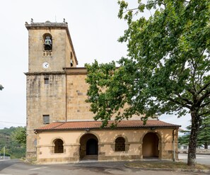 A historic building with a bell tower and arched entrance.