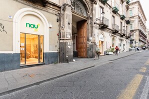 A storefront with a modern design, featuring a glass entrance and a sign with the logo "nau".