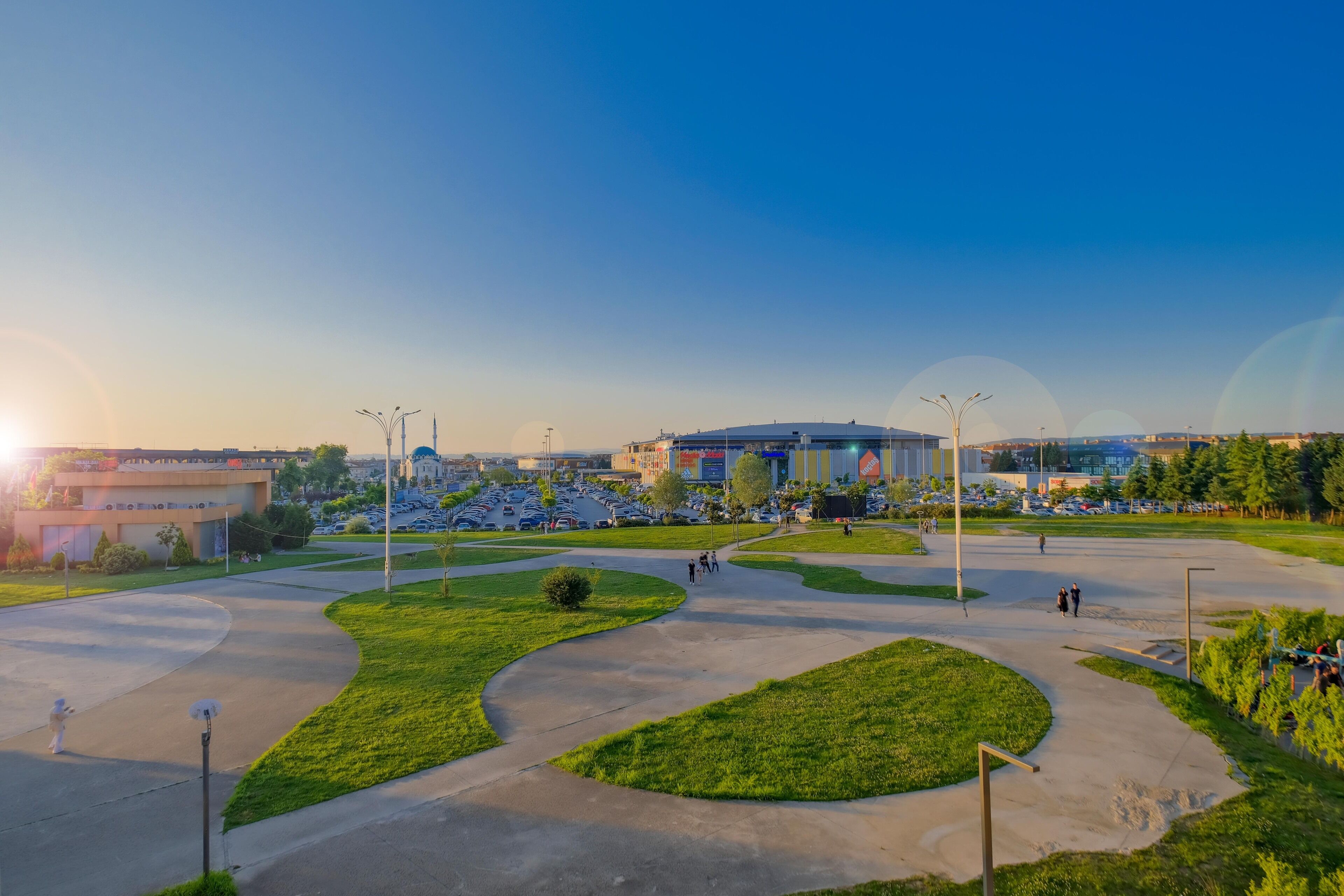A spacious parking lot with curved pathways and green landscaping.