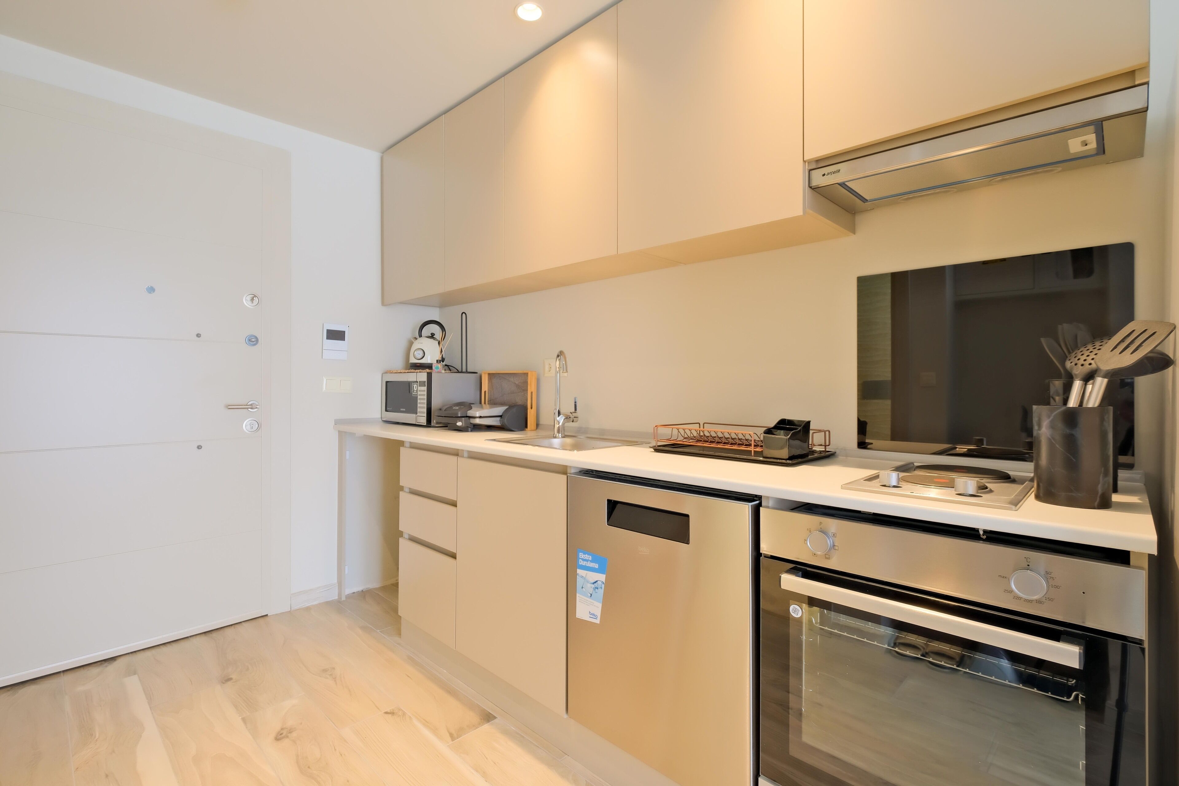 A modern kitchen with stainless steel appliances, a built-in oven, and a microwave.