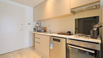 A modern kitchen with stainless steel appliances, a built-in oven, and a microwave.