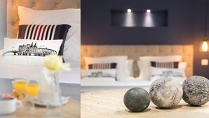 A modern bedroom with a tufted headboard, a bed with patterned pillows, and a bedside table with a vase and glasses.