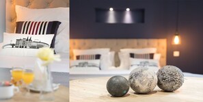 A modern bedroom with a tufted headboard, a bed with patterned pillows, and a bedside table with a vase and glasses.