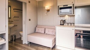 A compact kitchenette with a microwave, oven, and coffee maker.