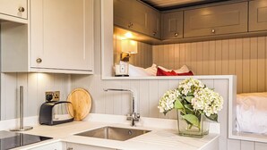 A modern kitchen with a built-in oven, a sink, and a toaster.