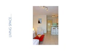 A modern living space with a dining area, a kitchen, and a hallway.