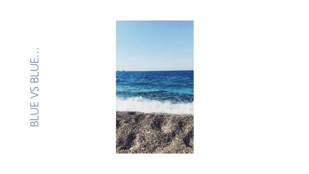 A beach with waves crashing onto the shore and a clear blue sky.
