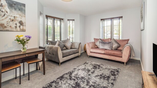 A living room with two sofas, a coffee table, and a TV.