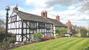 A traditional half-timbered building with a sign reading "Holt's Arms."