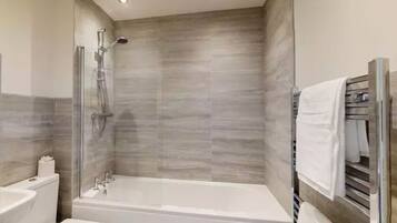 Bathtub, hair dryer, towels, soap