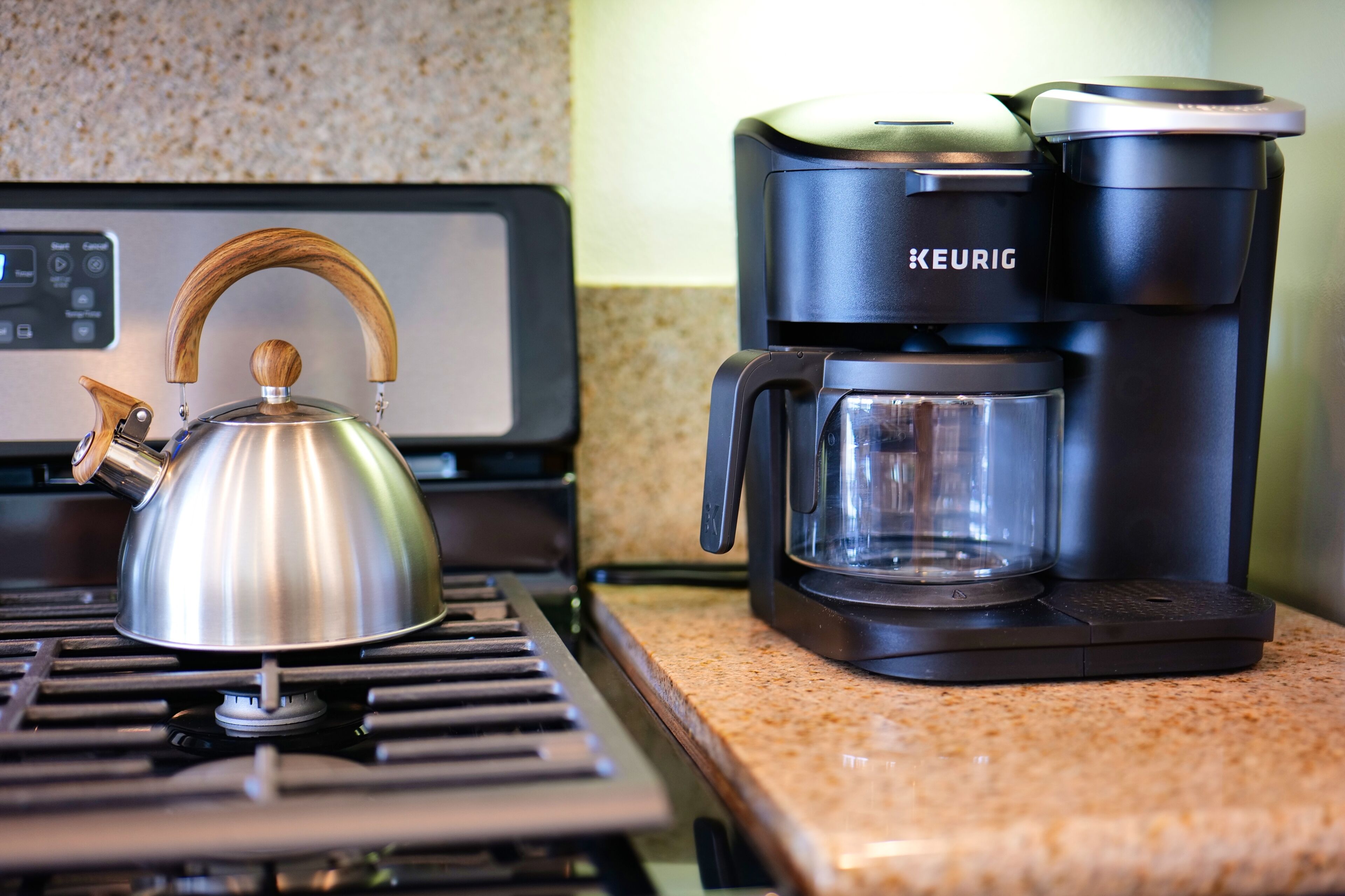 Ein Wasserkocher und eine Kaffeemaschine auf einer Küchenarbeitsplatte.