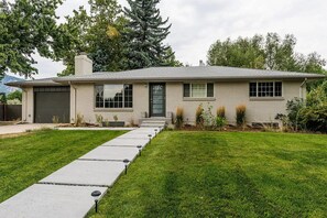 A single-story house with a front yard, a driveway, and a garage.