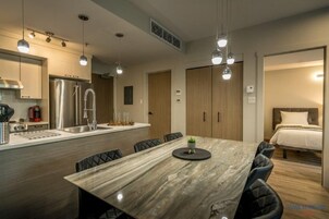 Luxury Condo, 1 Bedroom | Private kitchen | Coffee/tea maker, highchair, dining tables