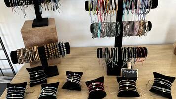 Un présentoir à bijoux avec des bracelets et des coussins décorés de perles.