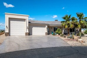 A two-story house with a garage and a driveway.