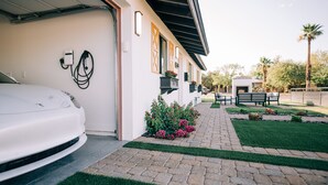 A white car parked in a driveway with a paved path leading to a building. - Glam Designer House with a Pool, Walk to Old Town (Scottsdale)