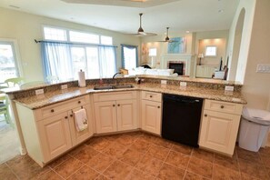 Enjoy cooking in this kitchen with a dishwasher, sink, and ceiling fan.