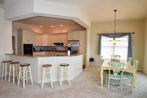 Enjoy meals in the spacious kitchen with a central island, oven, and dining area.