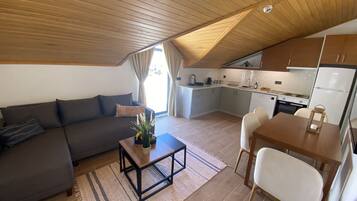 Deluxe Apartment | Living area | 32-inch Smart TV with satellite channels, TV