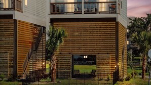 A multi-story building with balconies, a wooden facade, and a sign indicating 'FORCE'.