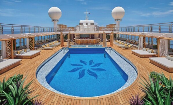 A cruise ship deck with a central swimming pool, sun loungers, and two large satellite domes. - The Grand Mayan 1x1 Suite (Cabo San Lucas)