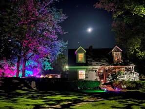 A house with a visible front yard, a visible moon in the sky, and a visible tree with colorful lights. - Gorgeous home outdoor covered bar  & minutes from floats, cliffs, tubing (Cabool)