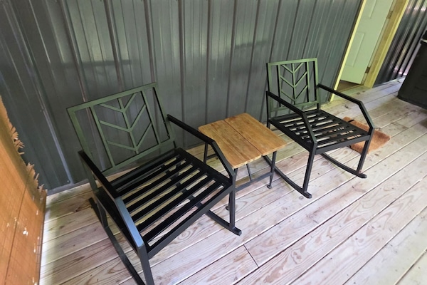 Two chairs and a small table on the deck