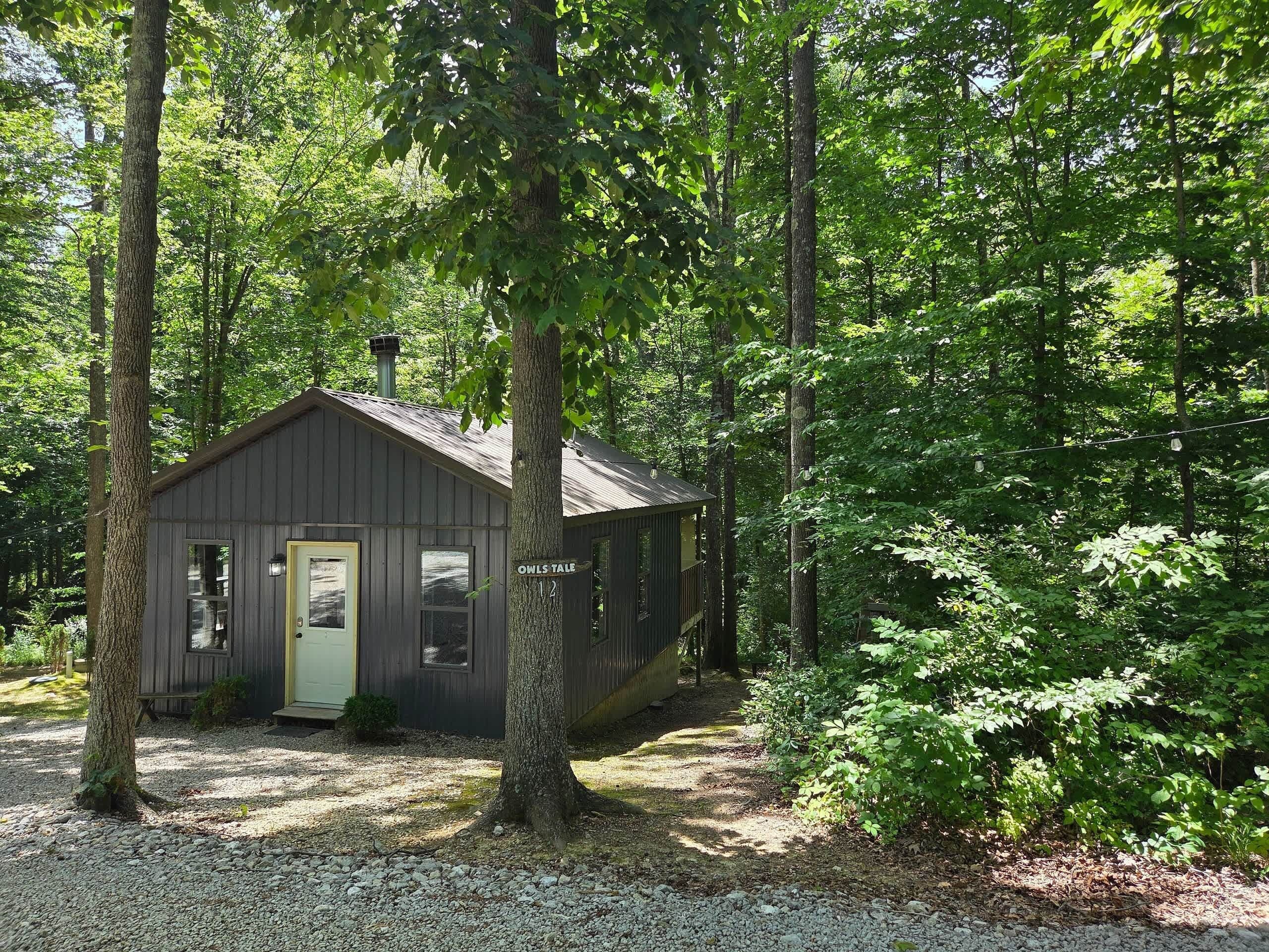 Cabin in the woods with the Owl's Tale sign