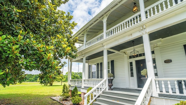 A two-story house with a porch, steps, and a garden. - Stunning historic home w/ large rooms. Close to attractions. Kid & pet friendly! (Sellers)