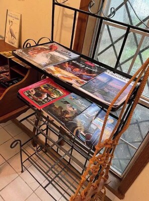 Cozy reading nook with a window, metal rack, and rope detail.