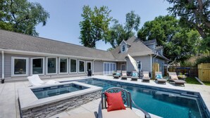 A backyard with a swimming pool, lounge chairs, and a covered patio area. - The Nashville Oasis | Ultimate Outdoor Escape (Nashville)