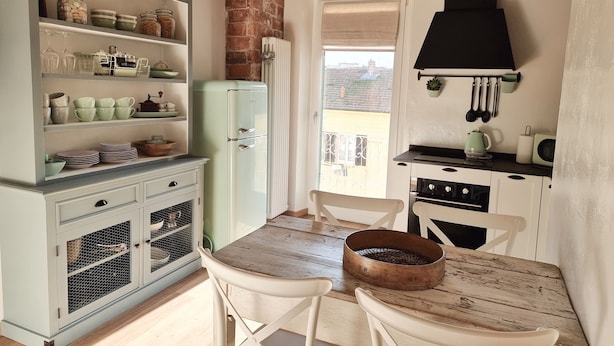 A kitchen with a vintage refrigerator, white cabinets, and a dining table with chairs. - CadeFe Loft loft in historic downtown (La Spezia)