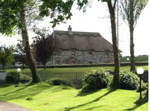 Traditional building surrounded by lush greenery in a serene setting.