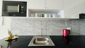 Apartment | Private kitchen | Fridge, microwave, oven, stovetop - Bright Studio Sleeps 3 With Parking and City View (Cagayan de Oro)